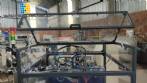 Pick and place product feeder for flowpack transfer cartoning machine