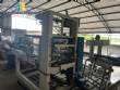Automatic baling machine with shrink tunnel for bottles and jars in bales.