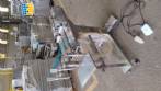 Filling machine with 2 nozzles for liquids and pilfer cap screwer