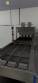 Automatic stainless steel deep fryer for donuts and cream puffs.