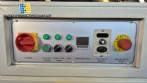 L-shaped packaging sealer with semi-automatic shrink tunnel.