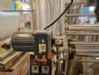 Vertical wrapping machine for triangular format