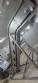Inova Industrial inclined stainless steel conveyor belt with cleats.