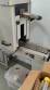 Label applicator machine with steam-operated shrink tunnel for sleeves.