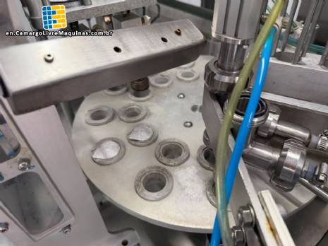 Tambflex Automatic rotary filling, dosing, and sealing machine for communion cups and small cups.