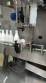 Labeling machine with steam sleeve tunnel and bottle baler
