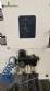 Labeling machine with steam sleeve tunnel and bottle baler