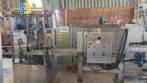Labeling machine with steam sleeve tunnel and bottle baler