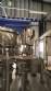 Zegla rotary filling machine with rinser and three-block capping system.
