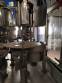 Zegla rotary filling machine with rinser and three-block capping system.
