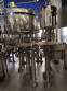 Zegla rotary filling machine with rinser and three-block capping system.