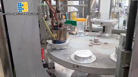 Rotary filling and dosing machine with capping and sealing unit for cups and bottles, capacity 2,000 units.